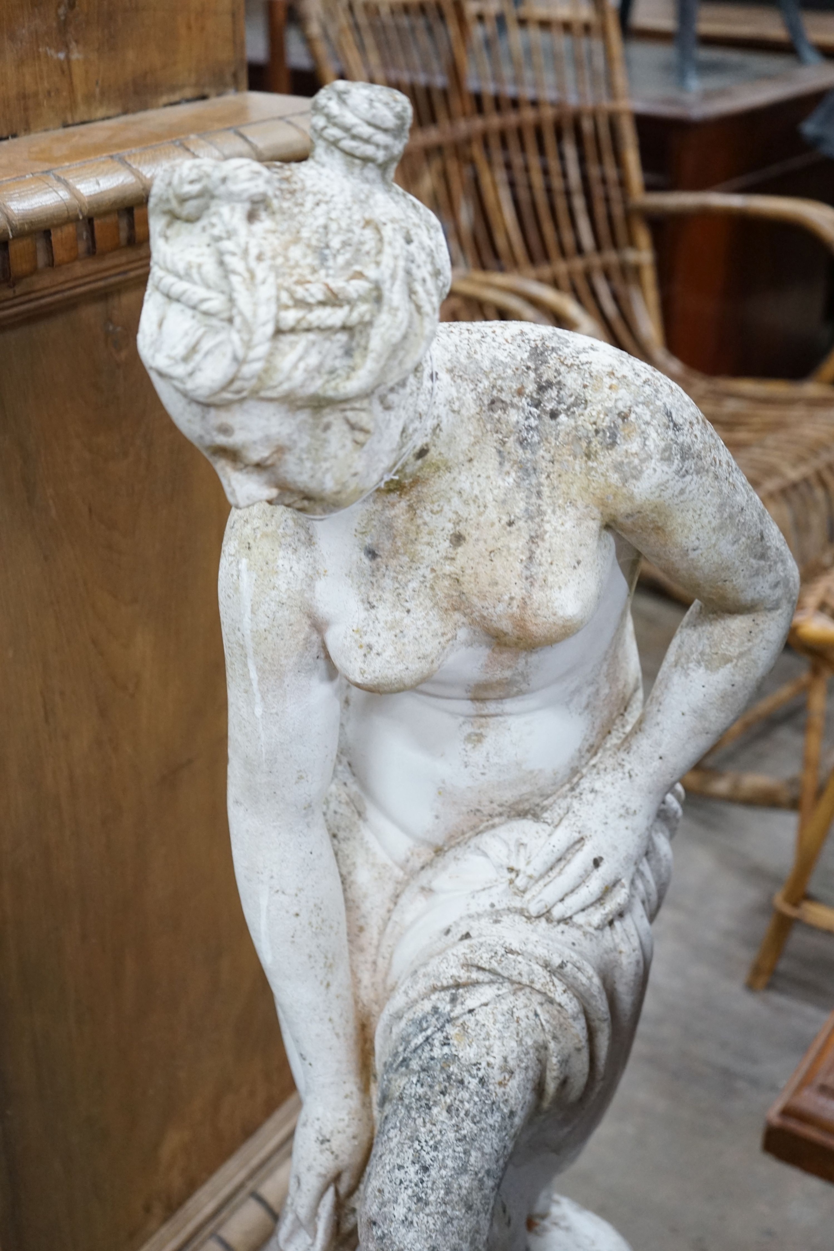 A reconstituted stone garden ornament of a female bather, height 102cm